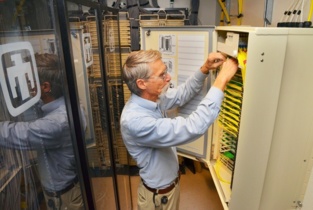 Steve Gossage, ingeniero en jefe en Sandia National Laboratories, mira la fibra óptica. Imagen: Randy Montoya. Fuente: Sandia Nartional Laboratories.