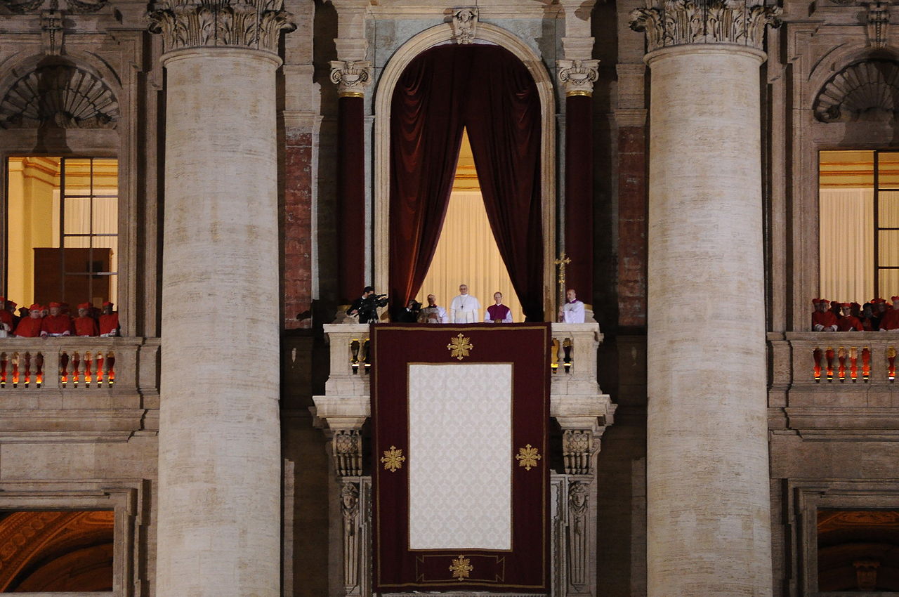 El papa Francisco, recién elegido, se asoma para saludar a la gente presente en la plaza de San Pedro. Imagen: Tenan - Trabajo propio. CC BY-SA 3.0. Fuente: Wikimedia Commons.