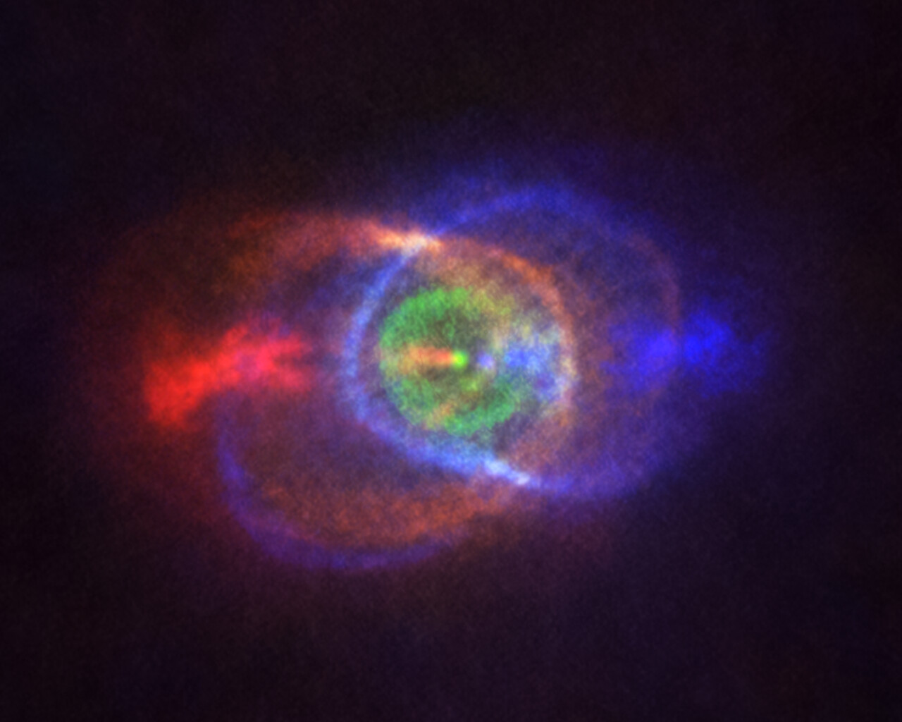La imagen muestra el resultado de una pelea estelar: un entorno de gas complejo y sorprendente que rodea el sistema binario HD101584 después de la agonía de las dos estrellas. Los colores representan la velocidad, pasando del azul (gas que se mueve más rápido hacia nosotros) al rojo (gas que se aleja más rápido de nosotros). Las estrellas del anterior sistema binario se encuentran ahora unidas en un único punto brillante situado en el centro de la estructura de anillo (en verde). Crédito:ALMA (ESO/NAOJ/NRAO), Olofsson et al. Acknowledgement: Robert Cumming